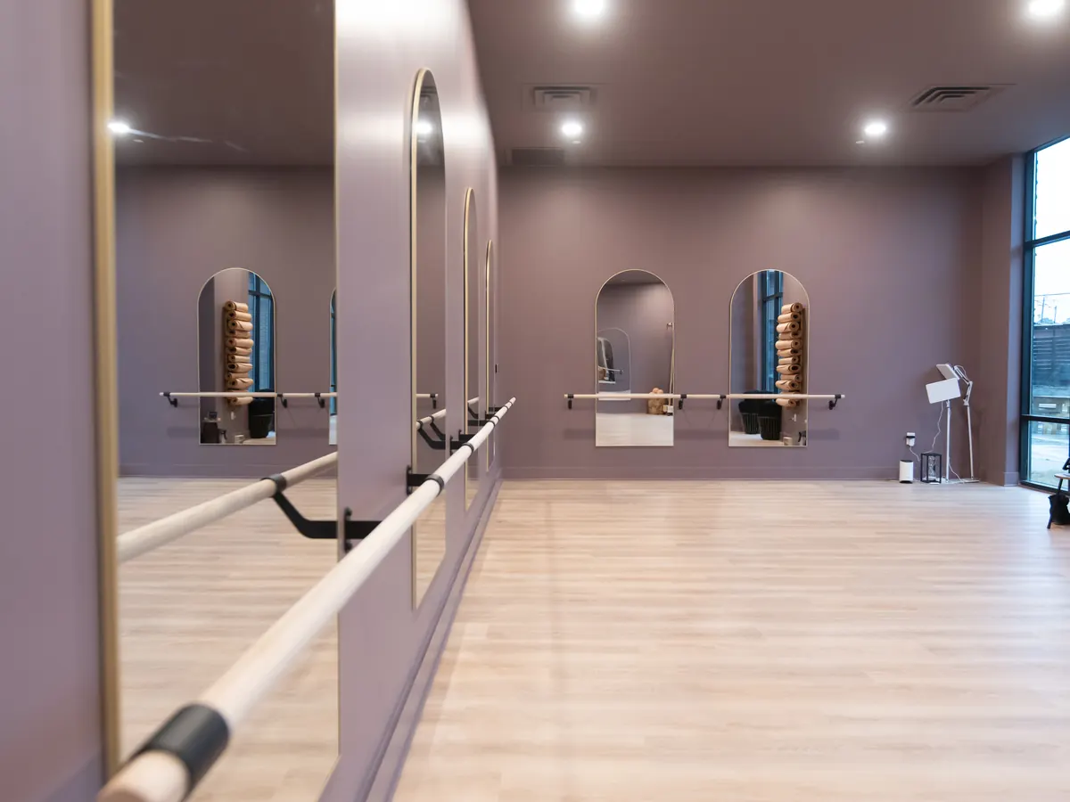 Rolesville studio room with ballet barres, arched mirrors, and mauve walls